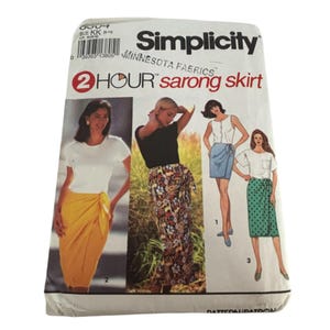 May include: Simplicity sewing pattern for a 2-hour sarong skirt. The package features illustrations of women wearing sarongs in various styles. The text includes "Minnesota Fabrics" and the size information.