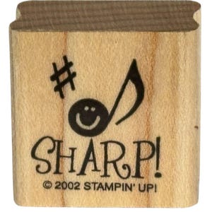 May include: A wooden stamp with the word "SHARP!" and a musical note with a smiley face. The stamp also features a sharp symbol and the text "© 2002 STAMPIN' UP!".