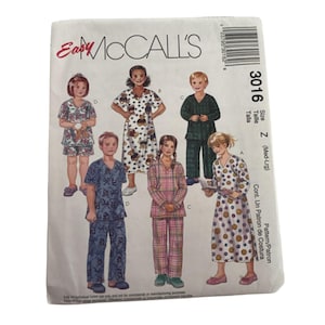May include: A McCall's sewing pattern envelope featuring illustrations of children's pajamas. The envelope has the text "Easy McCall's" and the number "3016". The pajamas have various patterns, including bears and plaid.