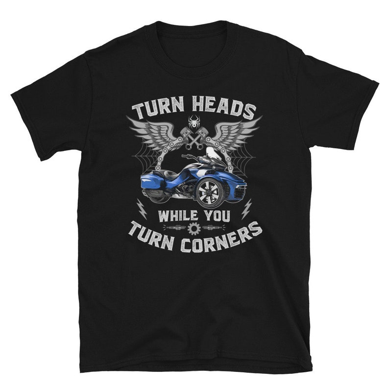 May include: Black t-shirt with a graphic of a blue three-wheeled motorcycle and the text "Turn Heads While You Turn Corners".