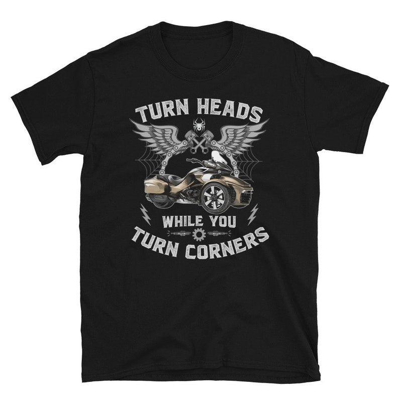 May include: Black t-shirt with a white graphic of a three-wheeled motorcycle with the text "Turn Heads While You Turn Corners".