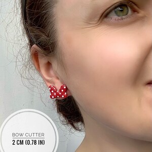 May include: Red and white polka dot bow earrings. The bow is 2 cm (0.78 in) wide. Bow Cutter.