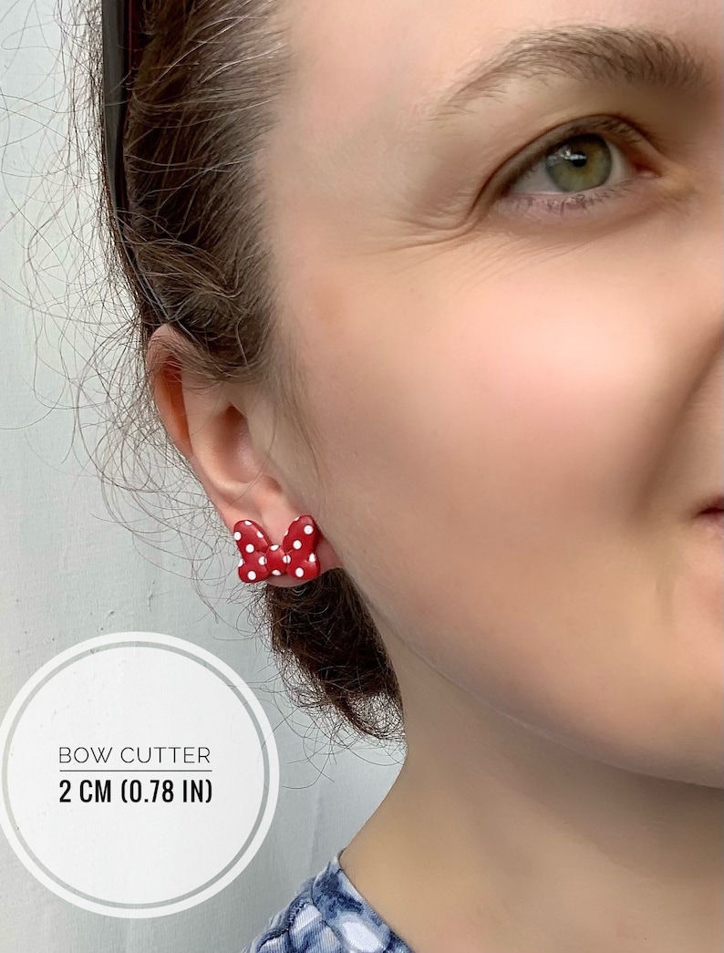 May include: Red and white polka dot bow earrings. The bow is 2 cm (0.78 in) wide. Bow Cutter.