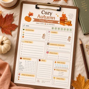 May include: A brown clipboard holding a printed Cozy Autumn Study Planner page. The planner features sections for priorities, deadlines, study tasks, assignments, habit tracking, water intake, and notes, decorated with orange pumpkin and book icons.