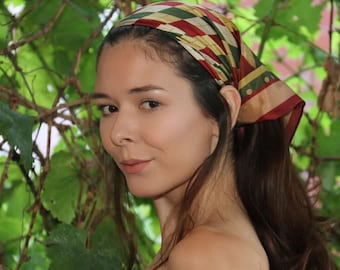 A multicolored Harlequin Silk Scarf with a captivating diamond pattern