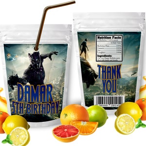 May include: A silver pouch with a black panther character from the movie Black Panther. The pouch has a blue and gold label with the text "DAMAR 5TH BIRTHDAY". The pouch is surrounded by orange and yellow citrus fruits.