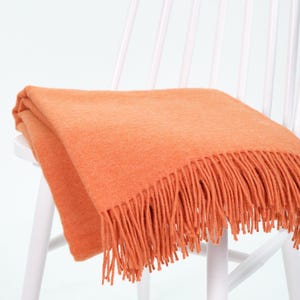 Bright orange wool throw blanket 140x200 cm (55x78 in) with fringe, warm cozy blanket for sofa or bed, minimalist home decor gift