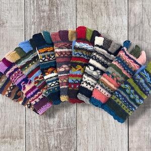 May include: A collection of fingerless gloves arranged in a fan shape, each featuring distinct multi-colored knit patterns with horizontal stripes, geometric shapes, and intricate textures in various shades of blue, green, red, purple, and brown.