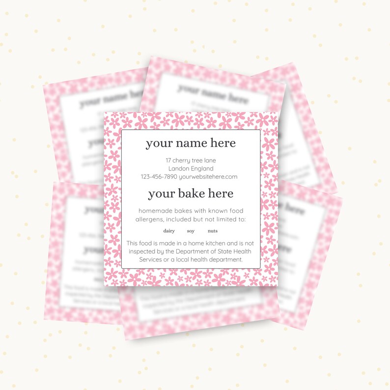 May include: Pink business card with a floral border and the text "your name here", "17 cherry tree lane", "Landon England", "123-456-7890 yourwebsitehere.com", "your bake here", "homemade bakes with known food allergens, included but not limited to: dairy, soy, nuts", "This food is made in a home kitchen and is not inspected by the Department of State Health Services or a local health department."