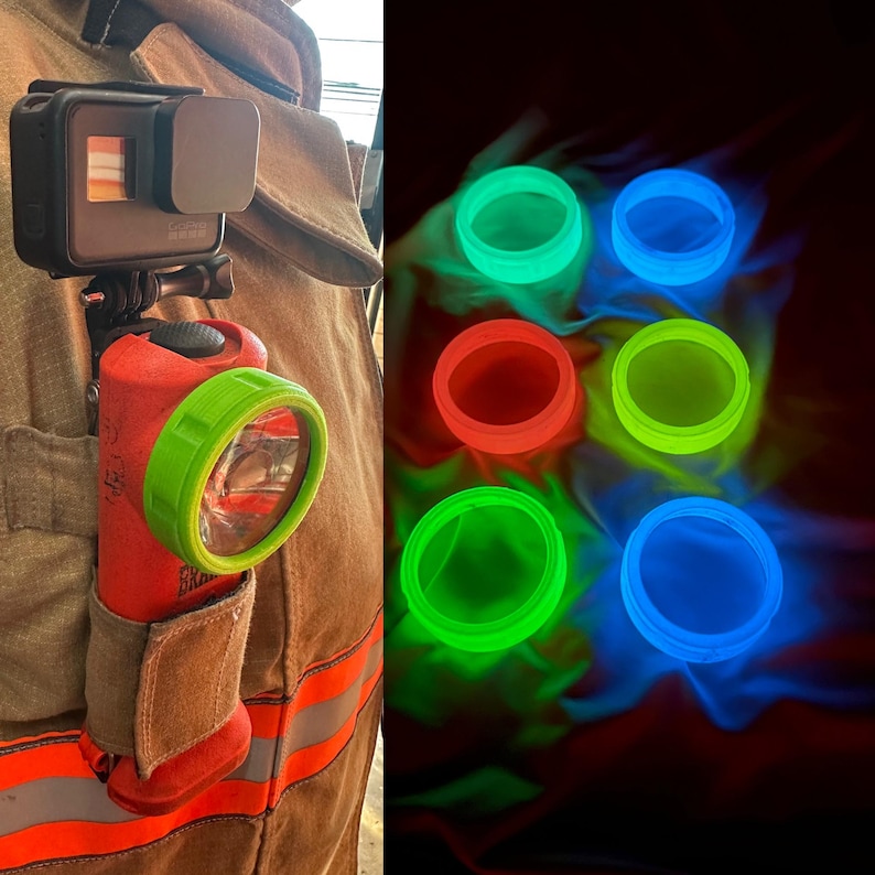 May include: A red flashlight with a green bezel is attached to a firefighter's uniform, with a black action camera. The image also shows several glowing, colourful rings in green, blue, and red, for visibility in low-light conditions.