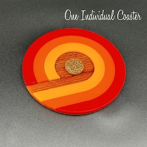 May include: A round, red, orange, and yellow coaster with a wood center and a gold glitter circle in the center.  One Individual Coaster.