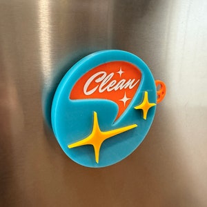 May include: A round blue and orange magnet with the word "Clean" in white lettering and two yellow stars.