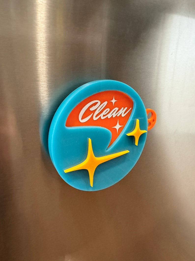 May include: A round blue and orange magnet with the word "Clean" in white lettering and two yellow stars.