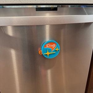 May include: A blue and orange dishwasher magnet with the word "Dirty" in white lettering and two yellow stars.
