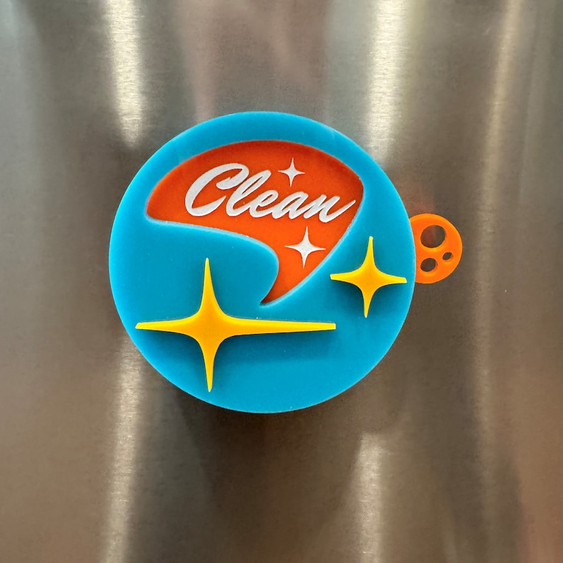 May include: A blue and orange round magnet with the word "Clean" in white lettering and a stylized star design.