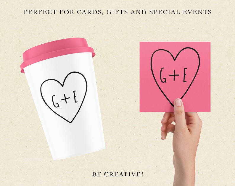 May include: A white to-go cup with a pink lid and a black hand-drawn heart with the text "G+E" inside. The cup is sitting on a beige surface. A pink sticky note with a black hand-drawn heart with the text "G+E" inside is being held by a hand.