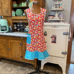 C. Women’s lady&#39;s apron, with ruffle and pocket, vintage or retro style, full length, red, yellow and turquo floral, thirties, forties style