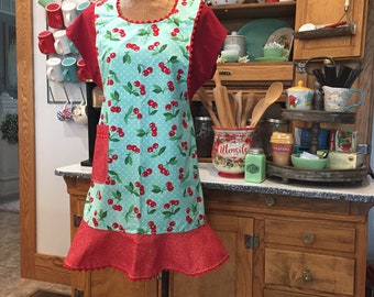 C. Women’s lady's apron, with ruffle and pocket, vintage or retro style with cherries. Aqua and red, full length