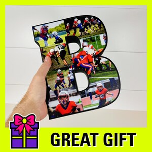 May include: A black wooden letter B with a collage of photos of children playing football. The letter is being held by a hand. The text "GREAT GIFT" is printed below the letter.