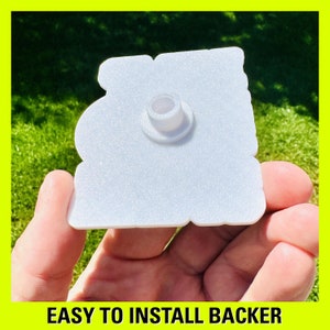 May include: White plastic backing with a hole in the centre for easy installation.