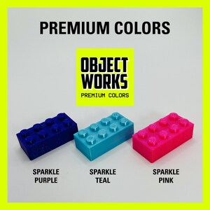 May include: Three plastic LEGO-style bricks in sparkle purple, teal, and pink. The bricks are labeled "Sparkle Purple", "Sparkle Teal", and "Sparkle Pink". The image also includes the text "OBJECT WORKS PREMIUM COLORS".