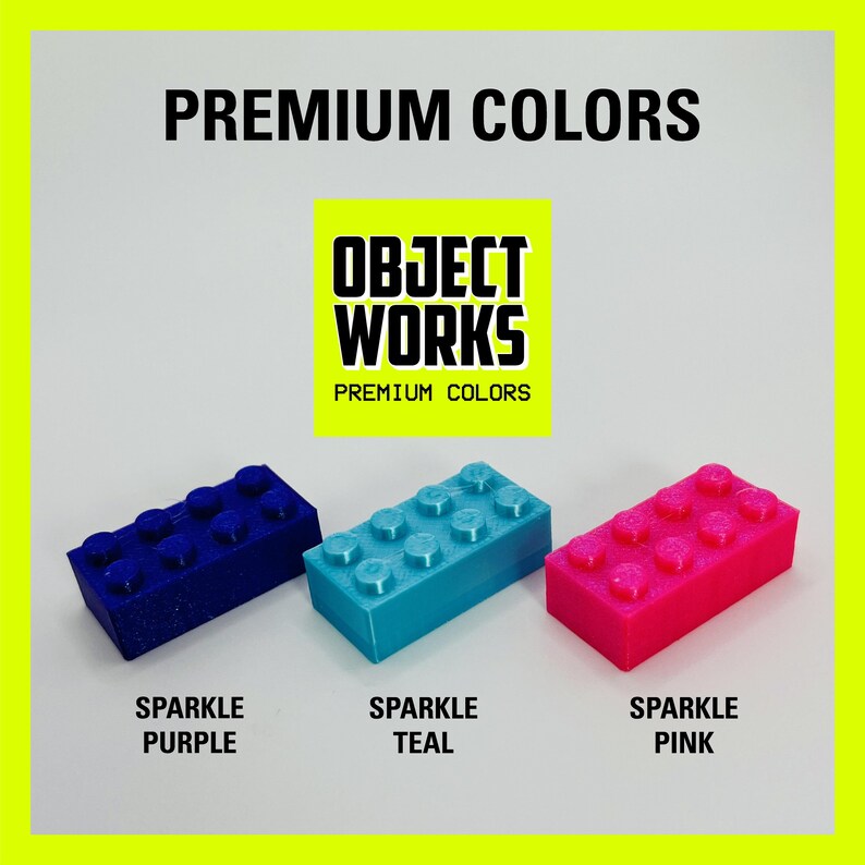 May include: Three plastic LEGO-style bricks in sparkle purple, teal, and pink. The bricks are labeled "Sparkle Purple", "Sparkle Teal", and "Sparkle Pink". The image also includes the text "OBJECT WORKS PREMIUM COLORS".