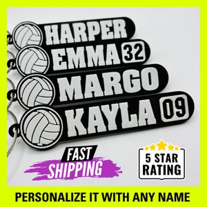 May include: Four black and white volleyball keychain tags with names and numbers. The tags feature a white volleyball graphic and white text on a black background. The text on the tags reads "HARPER", "EMMA 32", "MARGO", and "KAYLA 09".