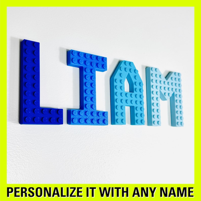 May include: Blue, light blue, and turquoise plastic letters spelling the name "LIAM". The letters are made to look like Lego bricks.