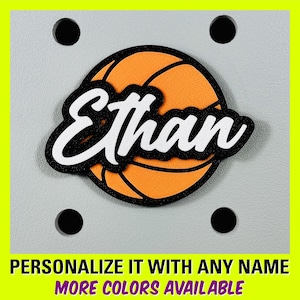 May include: A personalized basketball-shaped decoration with the name "Ethan" in white letters on a black background. The basketball is orange with black stitching.