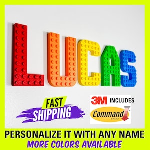 May include: A colorful name sign spelling "LUCAS" made of plastic blocks. The letters are red, orange, yellow, green, and blue. The sign includes 3M Command strips for easy hanging.
