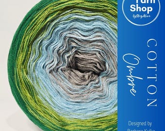 May include: A large ball of cotton yarn in a gradient of colors, including green, yellow-green, light blue, gray, and brown. The yarn is labeled "Cotton Ombre" and "Yarn Shop by StayAlive". Designed by Barbara Kulka.