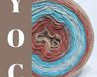 May include: A close-up of a ball of yarn with a gradient of colors including brown, teal, and beige. The yarn is tightly wound, showing the layers of color. The letters "YOC" are on a brown background.