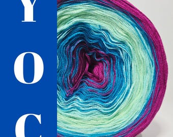 May include: A vibrant ball of yarn in shades of teal, magenta, and mint green. The yarn is tightly wound, displaying a gradient effect. The letters "YOC" are displayed in white on a blue background.