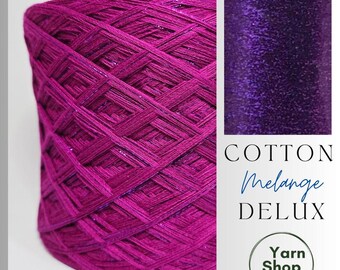May include: A large skein of magenta yarn with metallic threads. The image includes a swatch of deep purple, glittery fabric. Text reads "COTTON Melange DELUX" and "Yarn Shop by Stay Alive". Ideal for knitting and crochet projects.