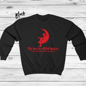 May include: Black sweatshirt with a red graphic of a person sitting on a crescent moon. The graphic says "ScreamWorks Never Sleep Again".