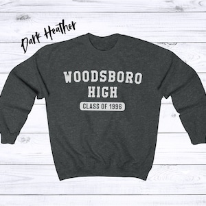 May include: Dark heather grey sweatshirt with the text "WOODSBORO HIGH CLASS OF 1996" in white.