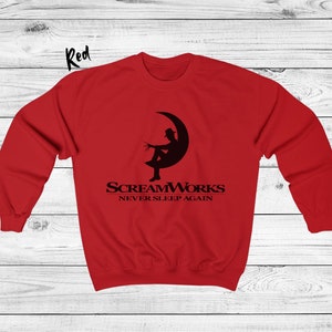 May include: Red sweatshirt with a black graphic of a person sitting on a crescent moon. The graphic includes the text "ScreamWorks Never Sleep Again".