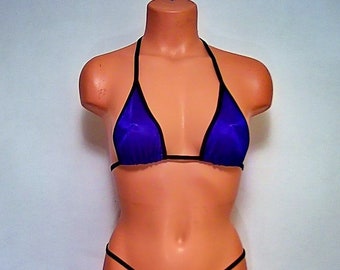 May include: A purple bikini top with black trim. The top is made of a sheer fabric and has a halter style.