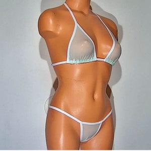 May include: White sheer mesh bikini top and bottom with white trim. The top is a halter style and the bottom is a thong style.
