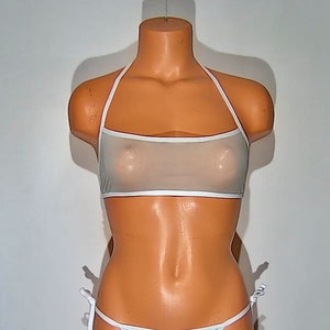 May include: White sheer halter top with a white trim. The top is made of a thin, delicate fabric and has a halter neck style.