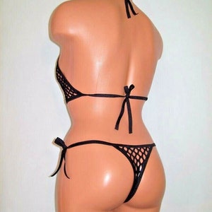 May include: Black mesh bikini top and bottom with adjustable ties. The bikini is made of a fine, stretchy mesh fabric.