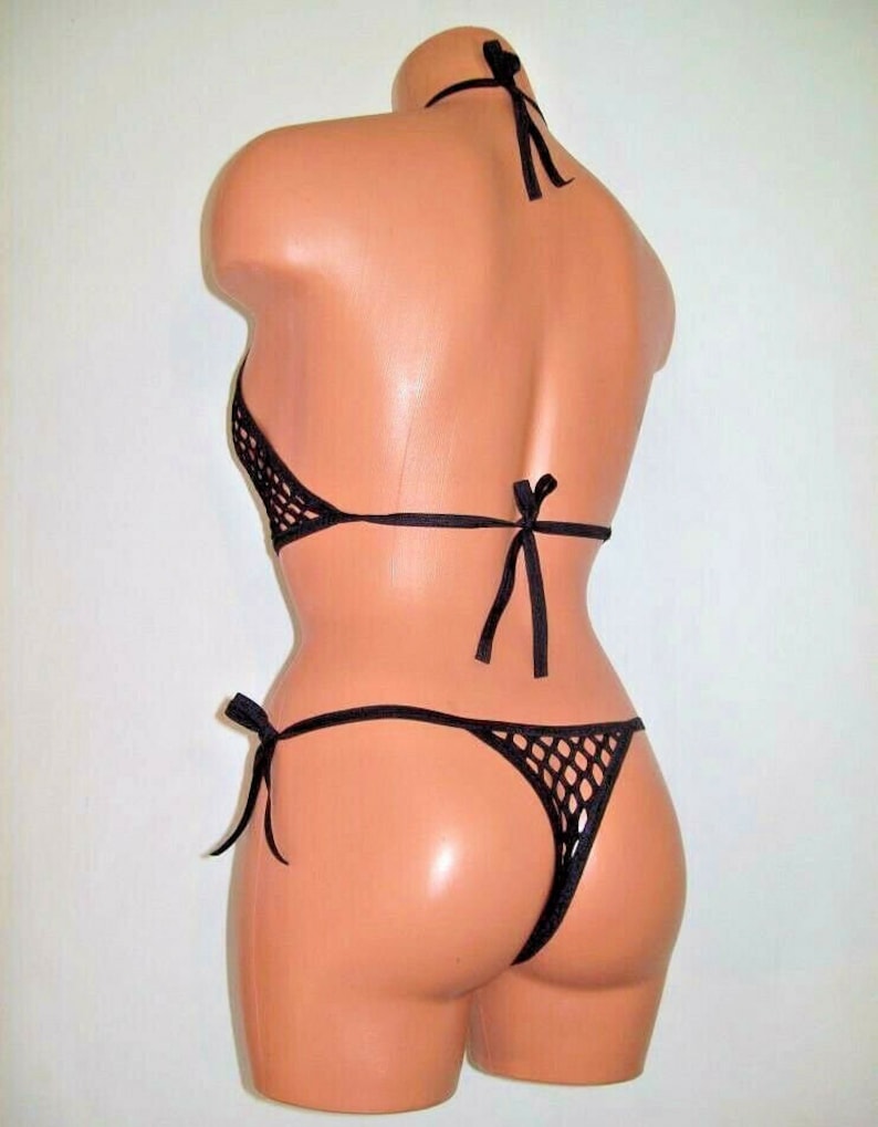 May include: Black mesh bikini top and bottom with adjustable ties. The bikini is made of a fine, stretchy mesh fabric.