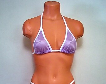 May include: Purple bikini top with white trim. The top is made of a sheer fabric and has a triangle shape.
