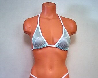 May include: A white and light blue bikini top with a sheer, mesh fabric. The top has a halter style with adjustable straps.