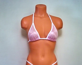 May include: A pink and white bikini top with a sheer fabric. The top has a triangle shape and white trim.