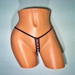 May include: Black sheer lingerie with a row of pearl-like embellishments down the center.
