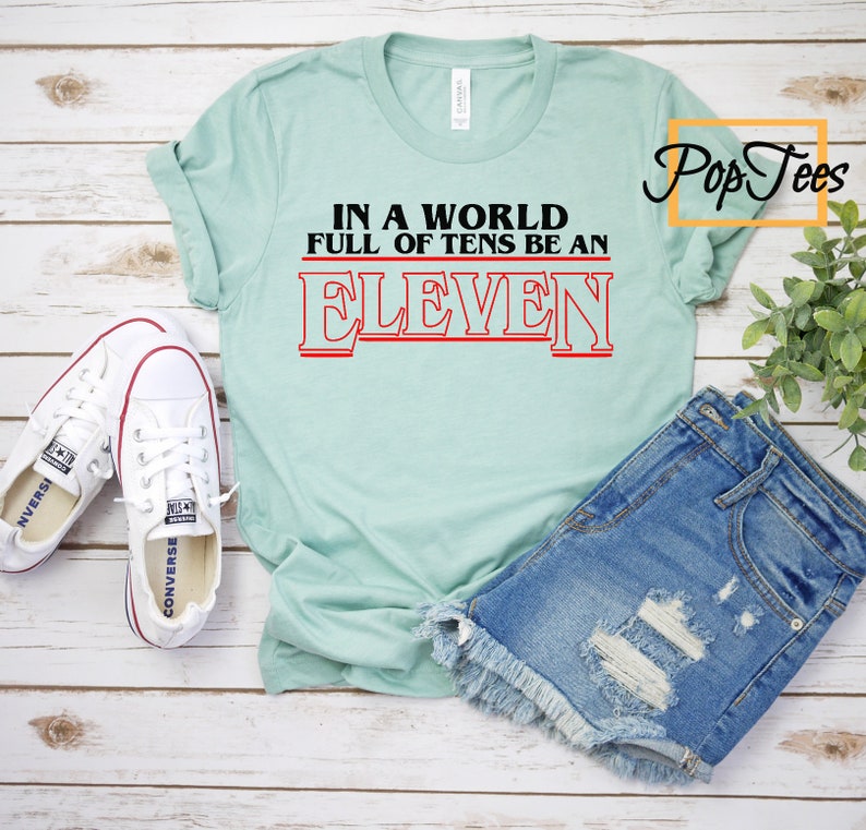 In A World Full Of Tens Be An Eleven  Unisex Tee. Stuck in