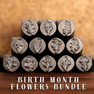 May include: A set of 12 metal stamps featuring different flower designs. The stamps are arranged in a pyramid shape and are labeled "BIRTH MONTH FLOWERS BUNDLE".
