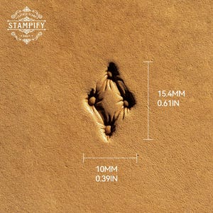 May include: A tan leather surface featuring a diamond-shaped stamped impression with four small circular accents. The stamp measures 15.4 mm or 0.61 inches in height and 10 mm or 0.39 inches in width. The Stampify logo is visible in the top left corner.