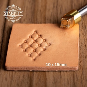 May include: A leather stamp tool and a piece of stamped leather. The leather is tan and has a diamond pattern with button details. The stamp tool is gold and silver. The leather piece measures 10 x 15mm.